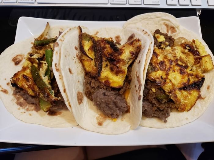 Close-up of three tacos served at 3C Hotels