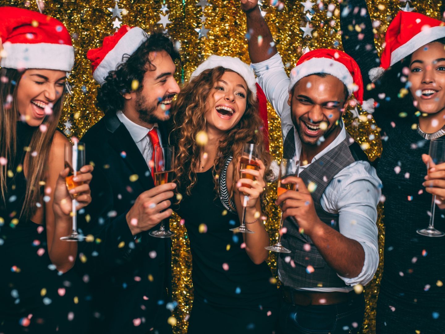 Friends celebrating a Christmas party with confetti & champagne at Hotel Grand Chancellor