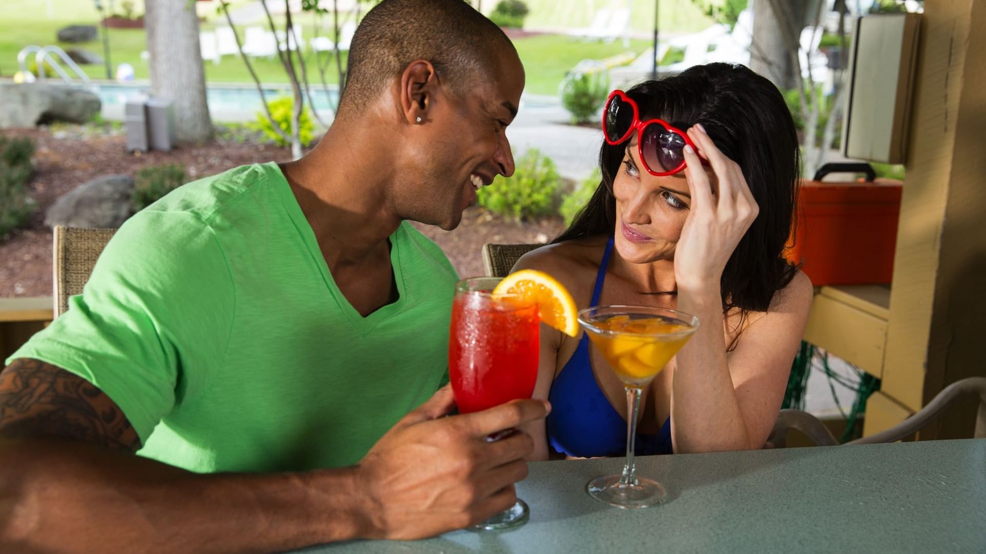 Couple gazing at each other while enjoying drinks from Tanlines Bar & Grill at Cove Pocono Resorts