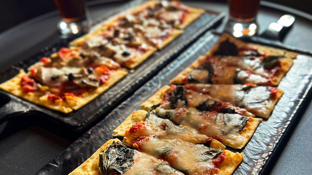 Close-up of flatbread and beer served in Midnight Sun Lounge at Midnight Sun, a Coast Hotel