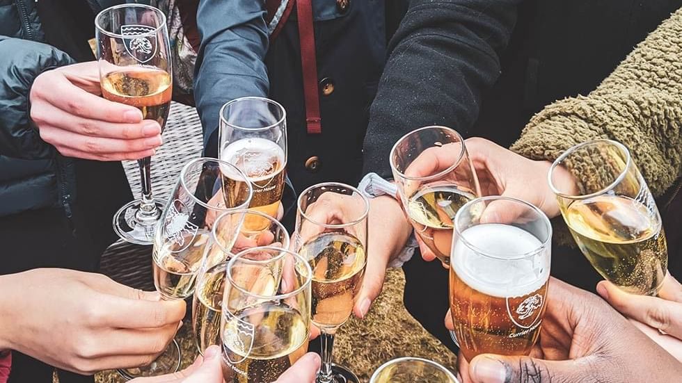 Close-up of friends toasting beer at Falkensteiner Hotel Bratislava