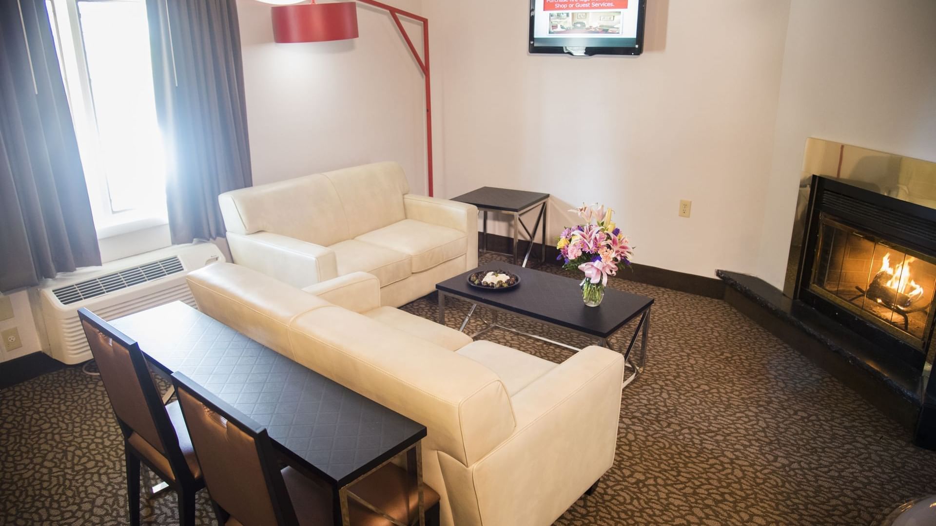 Living area in Champagne Tower with a fireplace at Cove Pocono Resorts