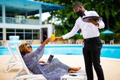 Woman drinking poolside
