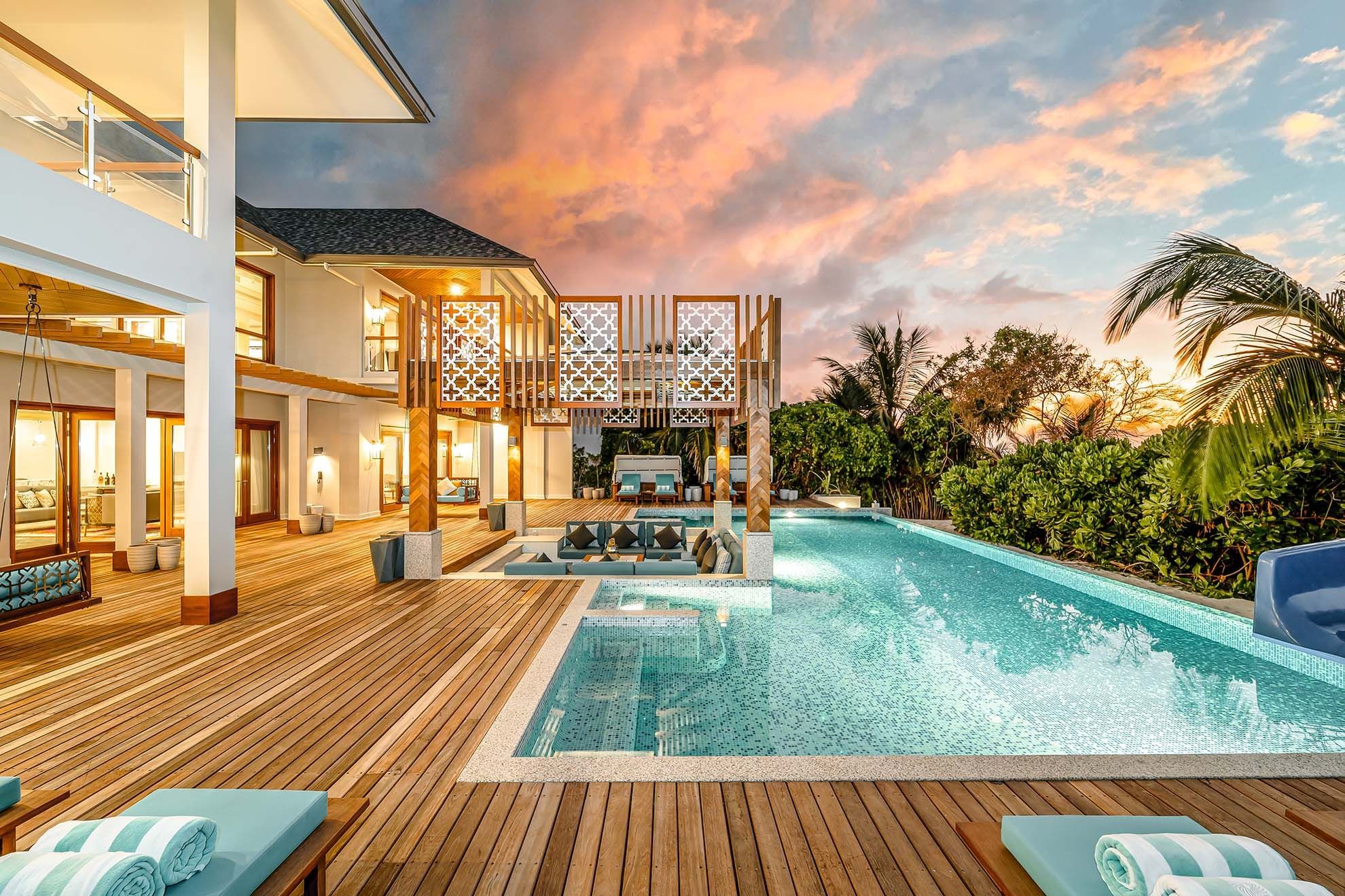 Loungers on a pool deck at The Signature Collection by Hideaway