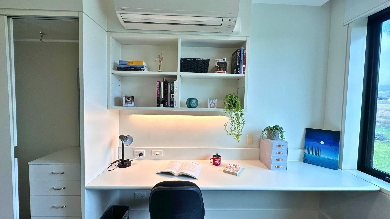 Modern student room with desk, chair, and built-in shelving at La Trobe University - McFarlane's Hill Residences.