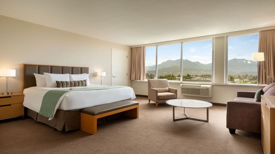 Bed in spacious hotel room with mountain views