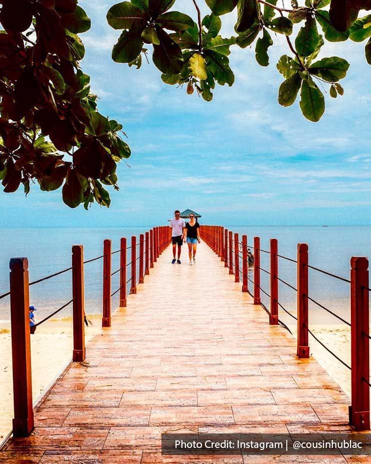 A couple were strolling along the wooden pier - Lexis Suites Penang