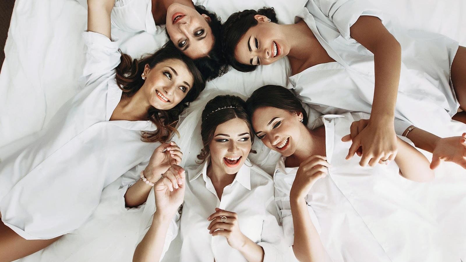 Bridesmaids laying on the bed at Live Aqua Urban Resort Mexico