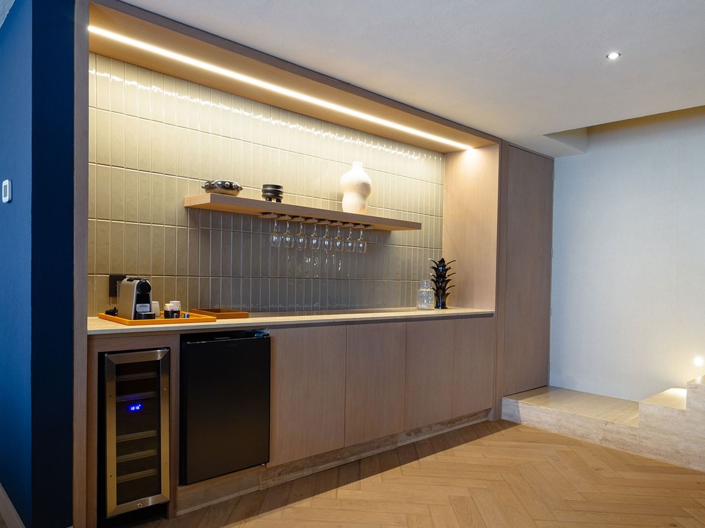 King Superior Viceroys Suite wet bar featuring a wine cooler, glassware, and ambient lighting at Camino Real Polanco Mexico