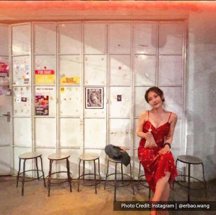 A lady styled in a red dress was sitting on a chair at Good Friends Club - Lexis Suites Penang