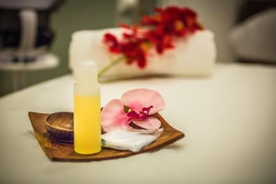 aromatic oils, candles and flowers over the bed of the spa