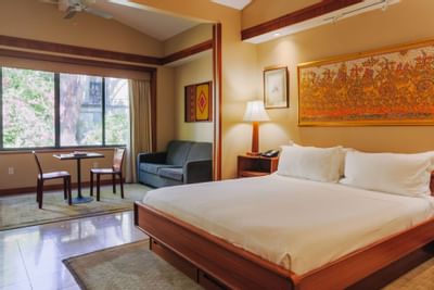 Large bed & lounge in Lanai Suite at Dinah's Garden Hotel