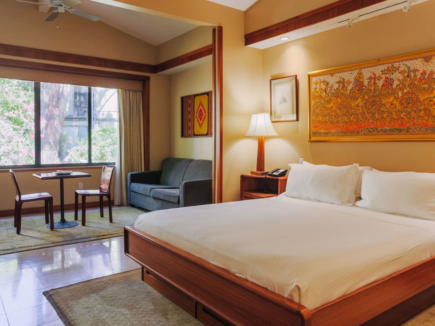 Large bed & lounge in Lanai Suite at Dinah's Garden Hotel