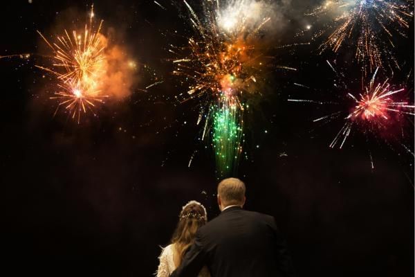 Bride and groom watching fireworks display a great New Years Eve Wedding Idea