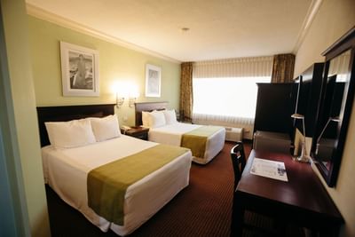 Two beds, desk & TV in Junior suite at Araiza Hotel Hermosillo