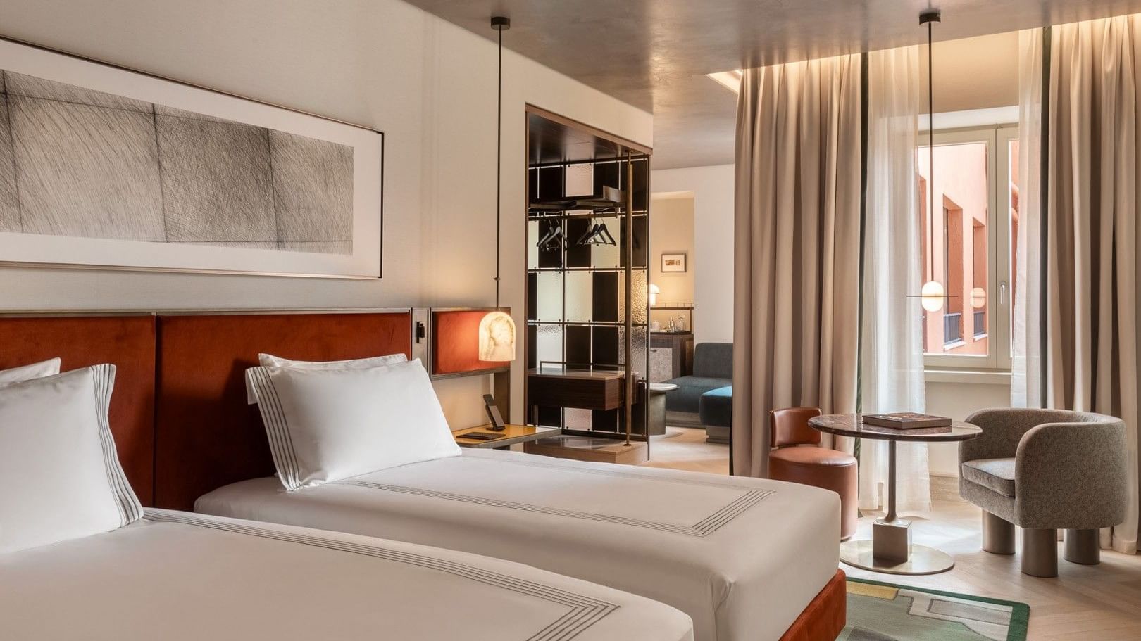 Two twin beds with wood headboards and white linens in a modern suite at The Thompson Rome, Roma.