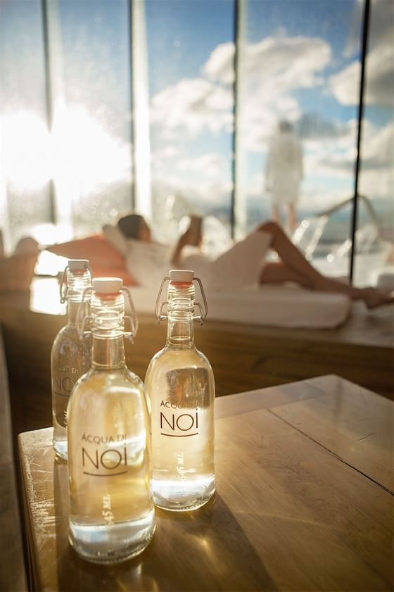 3 glass water bottles kept on table in Aiken Spa at NOI Indigo