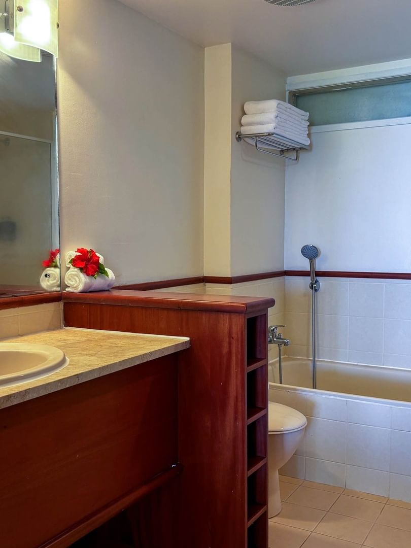 Bathroom with a bathtub and a sink at The Naviti Resort in Korolevu.