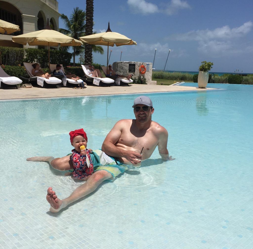 People relaxing by the pool at The Somerset on Grace Bay