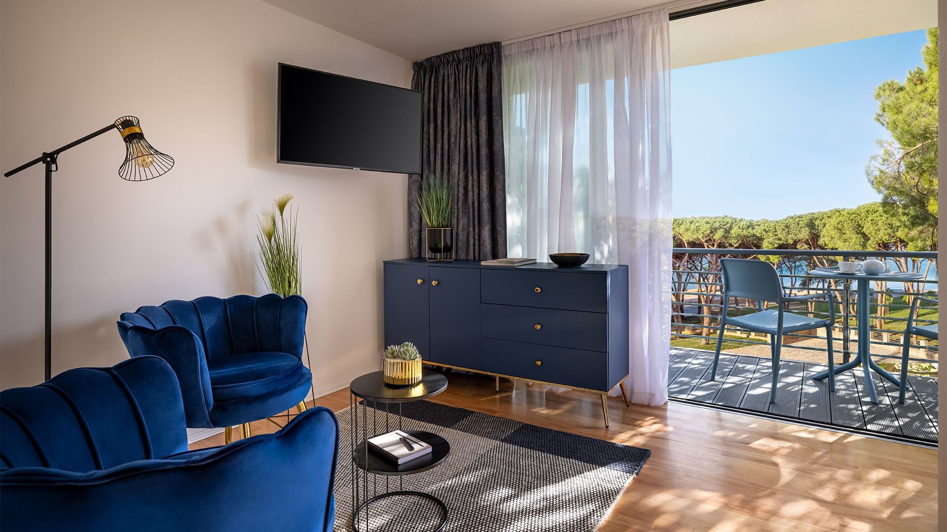 Interior of a living room with a balcony, TV & Seatings at Falkensteiner Hotels and Residences