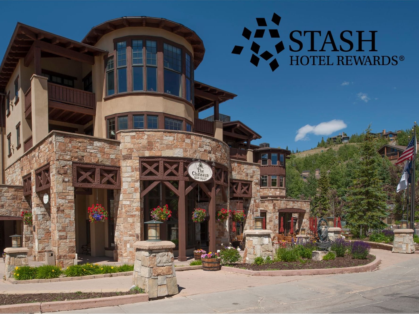 Stash Hotel Rewards poster with a background of hotel's exterior at Chateaux Deer Valley