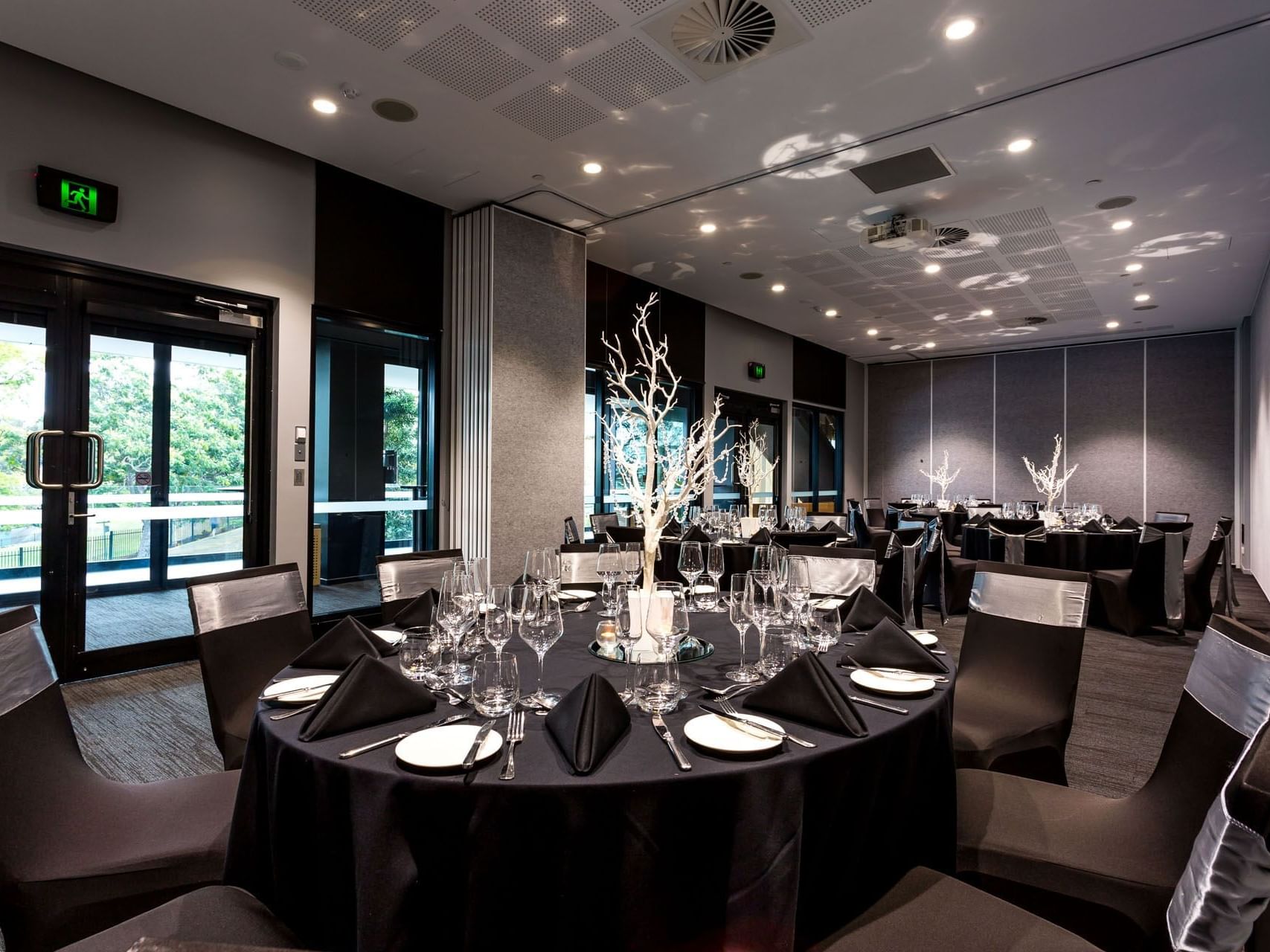 Table decor, candle holders & glassware on banquet tables in Chancellor 5 at Hotel Grand Chancellor Brisbane