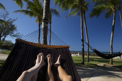 Two peoples on a Hammock at The Condado Plaza Hilton