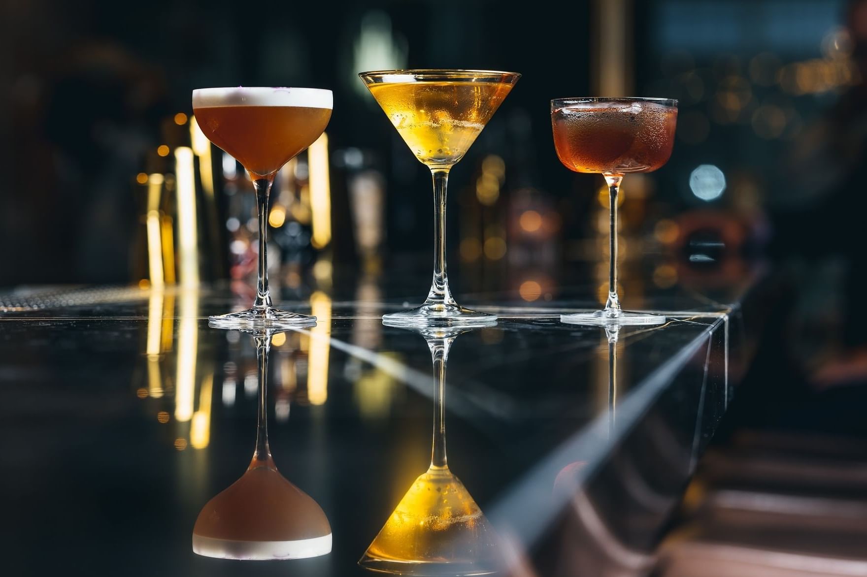 Close-up of Bombay Chai Sour, Bellini Au Thé and Bordeaux Manhattan cocktails served at The Stage in The Londoner Hotel