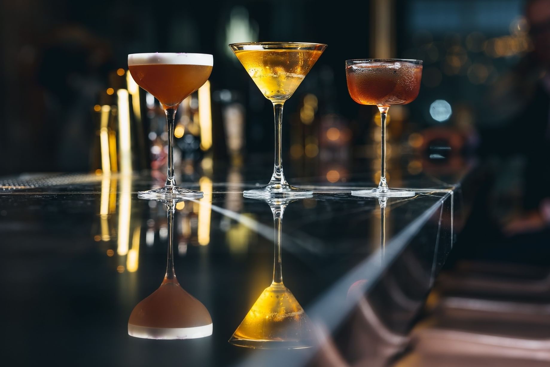 Close-up of Bombay Chai Sour, Bellini Au Thé and Bordeaux Manhattan cocktails served at The Stage in The Londoner Hotel