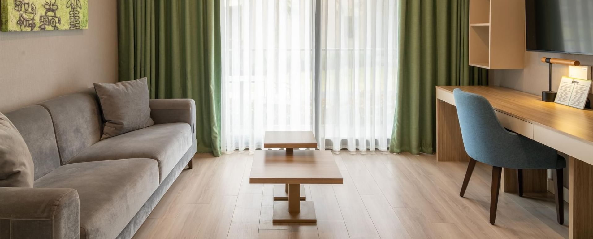 Seating area with workspace and floor to celling windows in Double Room at The Hub Acunmeyda