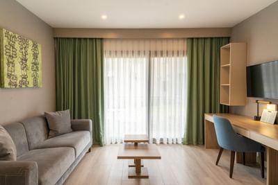 Seating area with workspace and floor to celling windows in Double Room at The Hub Acunmeyda