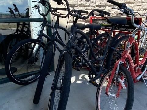 Row of bikes parked for complimentary bicycle borrowing services at Boothill Inn & Suites