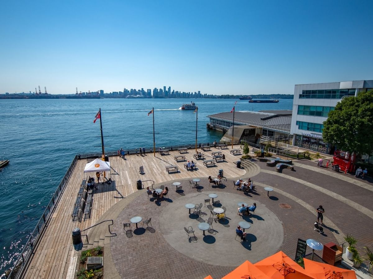 Waterfront area with a pier overlooking the city skyline of Vancouver at Coast Lonsdale Quay Hotel