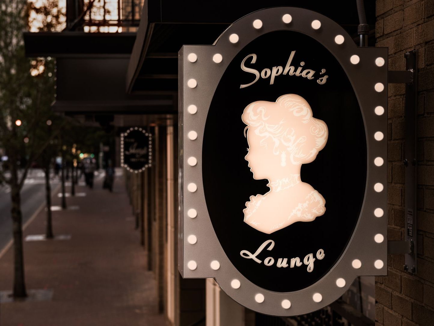Close-up of Sophia's Lounge sign board at Ivey's Hotel