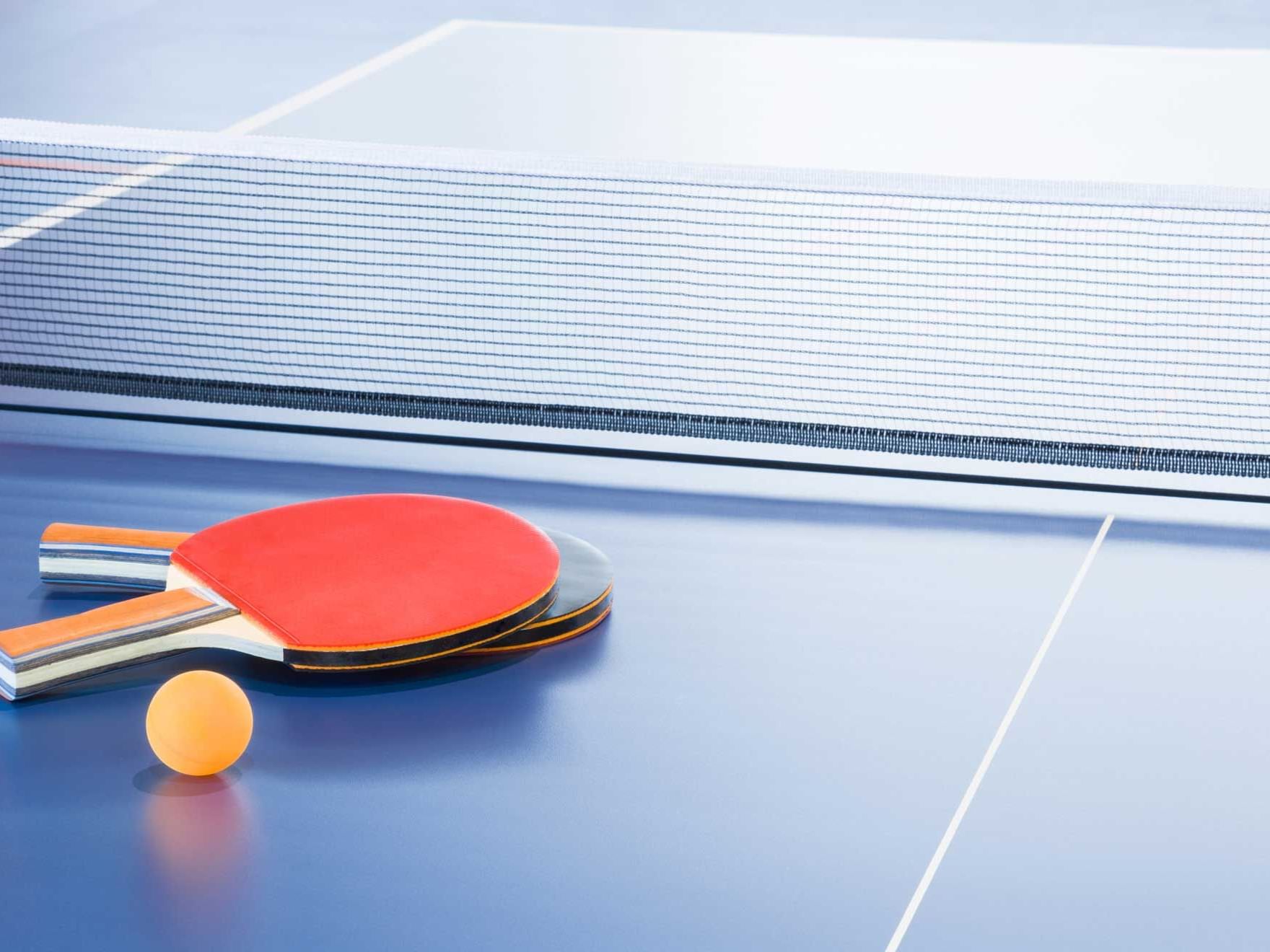 Rackets and ball on the blue tennis table at Silverwater Resort