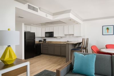 a couch and kitchen in a hotel room