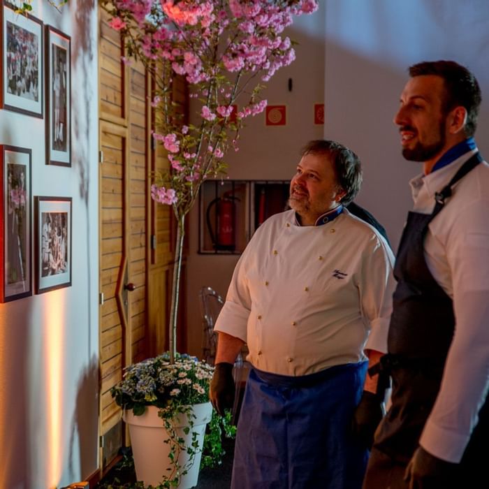 Two chefs looking at the wall pictures at Falkensteiner Hotels 