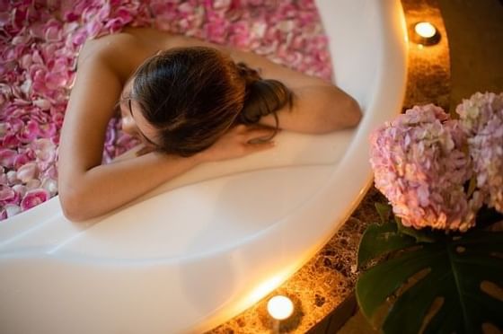 A lady on a jacuzzi pool in the spa at Okura Prestige Bangkok