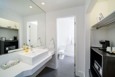 Bathroom vanity with lavatory in Deluxe King Room at Becks Motor Lodge