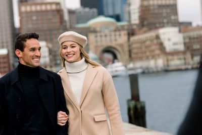 couple walking with the iconic archway in the background
