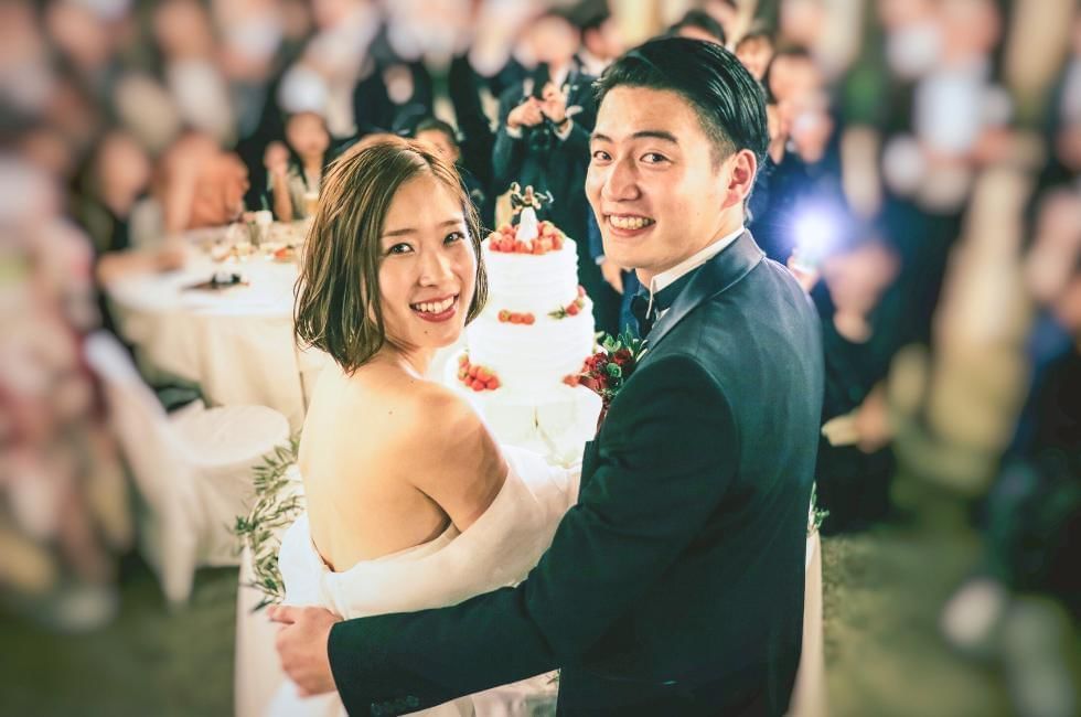 couple looking happy cutting cake on wedding day