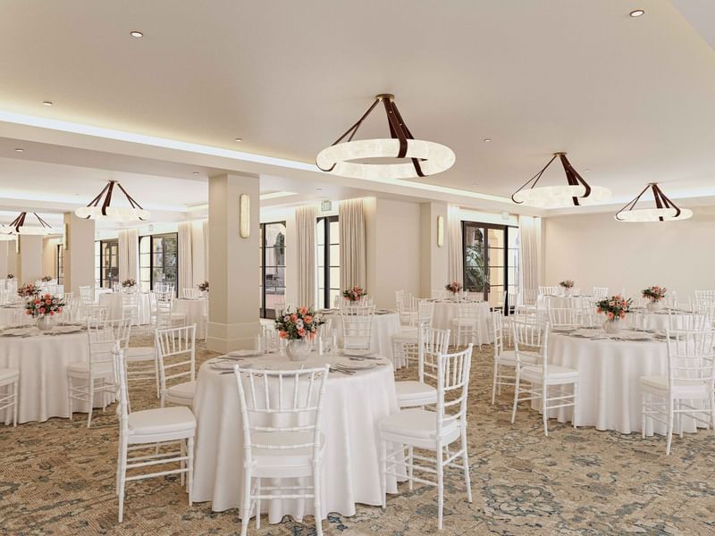 Courtyard Ballroom at El Prado Hotel, prepared for an event with white tables, chairs, and flowers