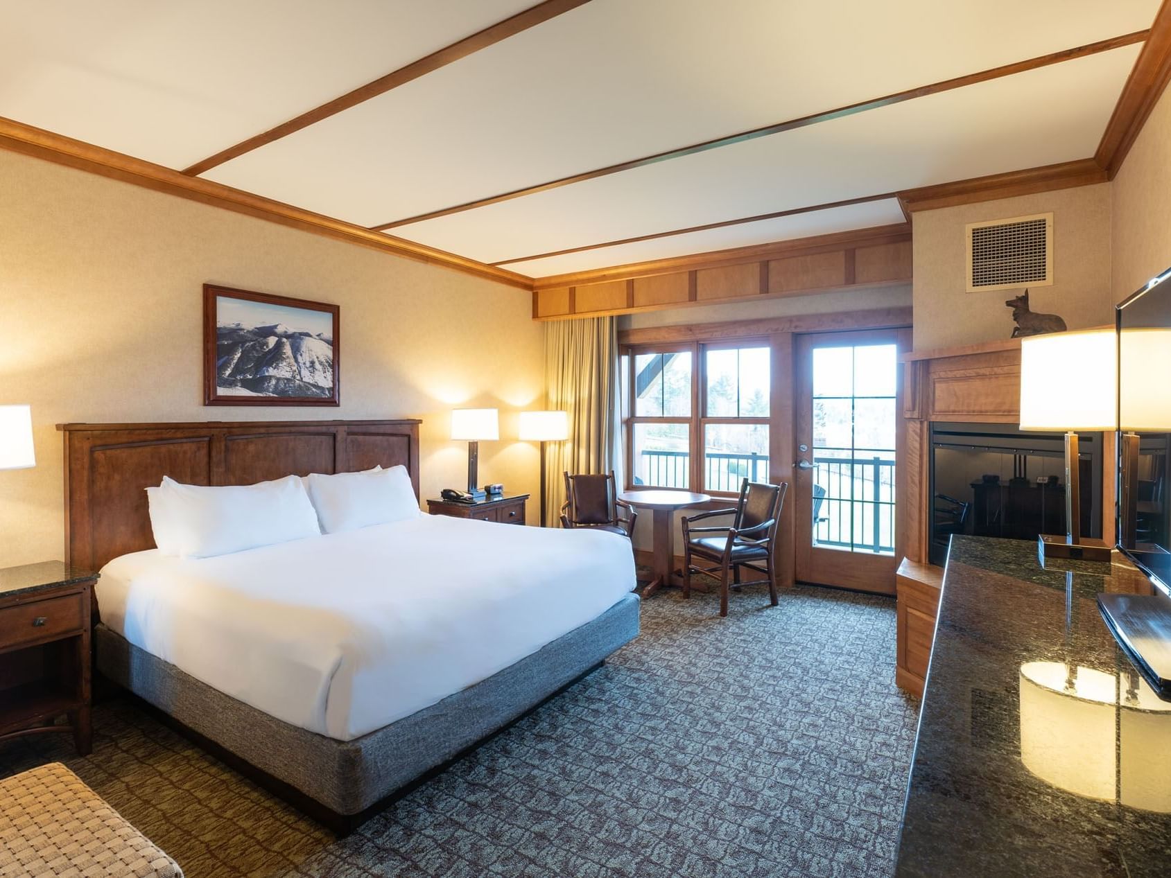 King Room at Lake Placid Club Grandview with a simple table and chairs by doors leading to a private balcony or patio.
