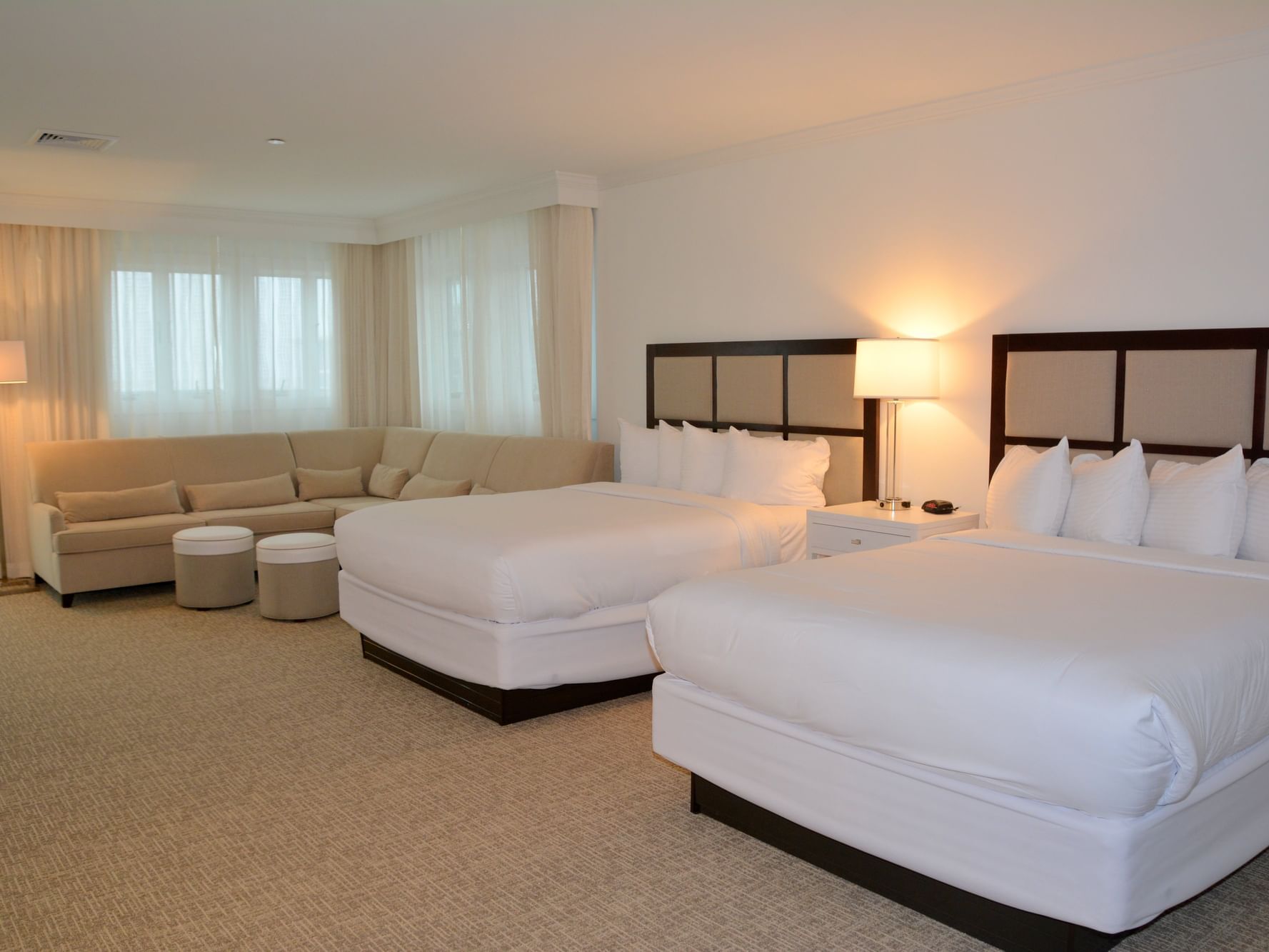 Two beds and sofa in Premium family suite at ICONA Avalon