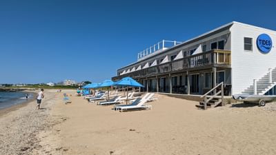 Sun lounges on the beach & hotel exterior at Falmouth Tides