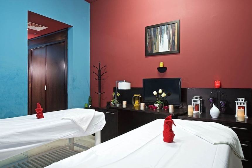 Two beds, towels in Massage Parlor at The Royal Riviera Hotel