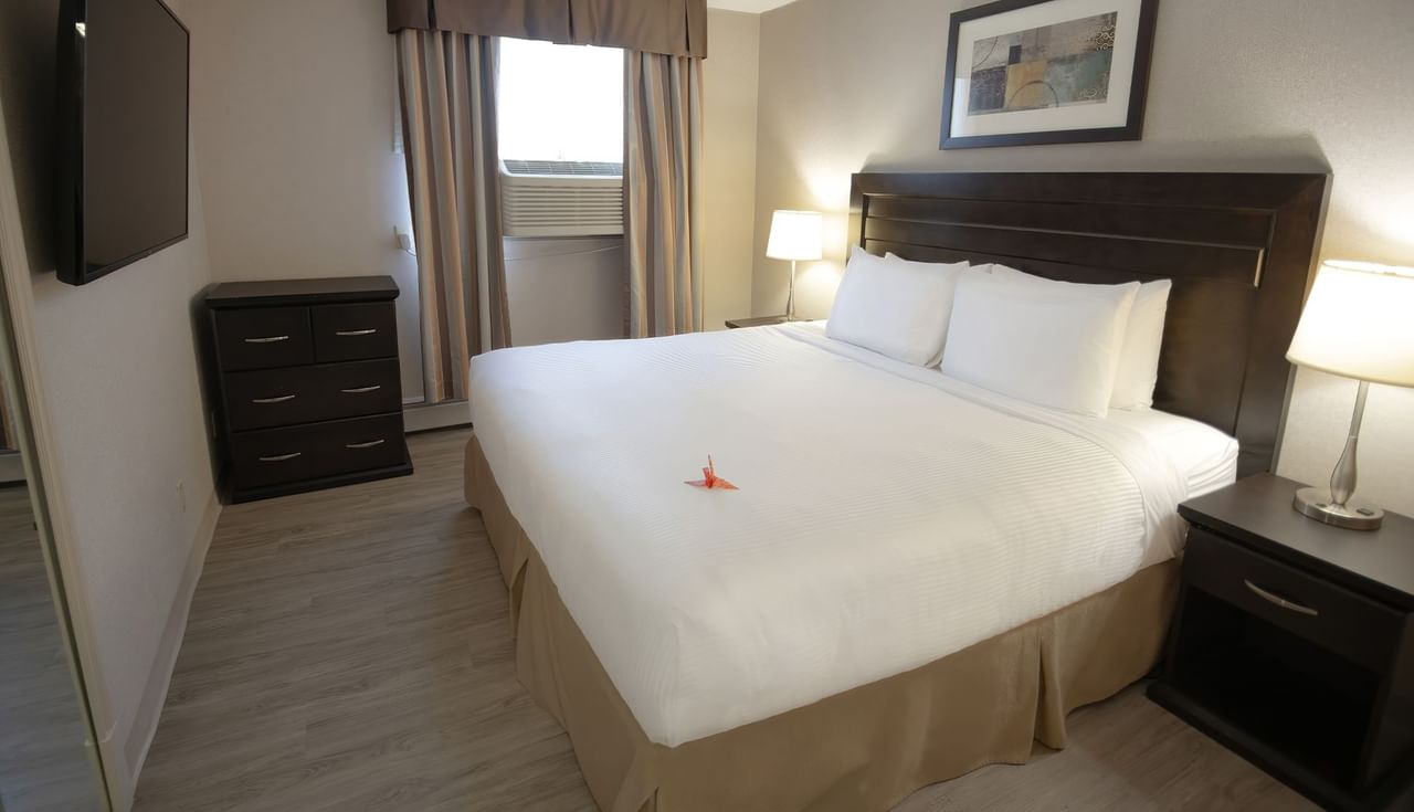 Hotel suite with king bed and a TV