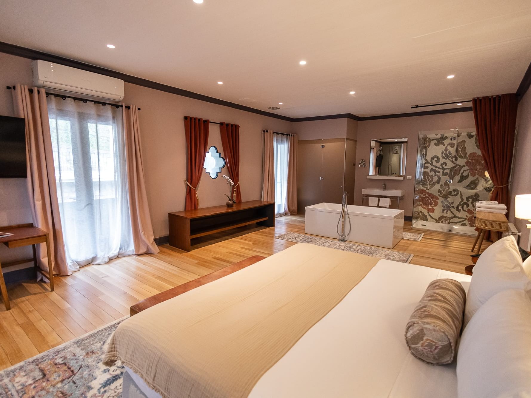 Presidential Suite with a large bed, TV, and bathtub near the bathroom at The Aubrey Hotel, hotel rooms in Santiago Chile