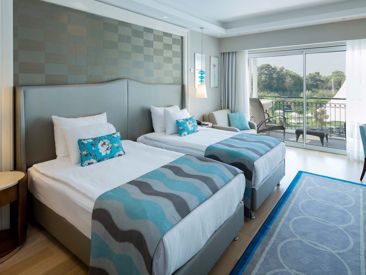 Lounger by the beds in Family Pool Balcony Suite with wooden floors at Titanic Deluxe Golf Belek