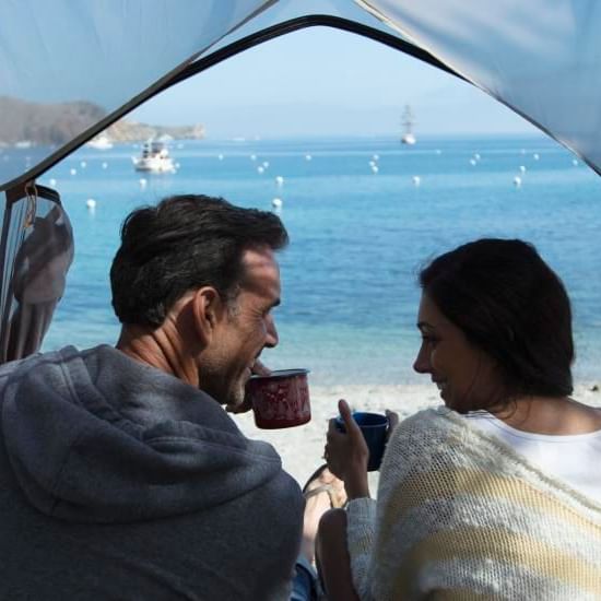 A couple enjoying tea while looking at each other at Catalina Island Company, one of the things to do in catalina island